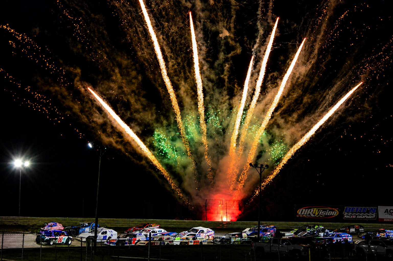 Comet fan of race track opening fireworks over the grandstand