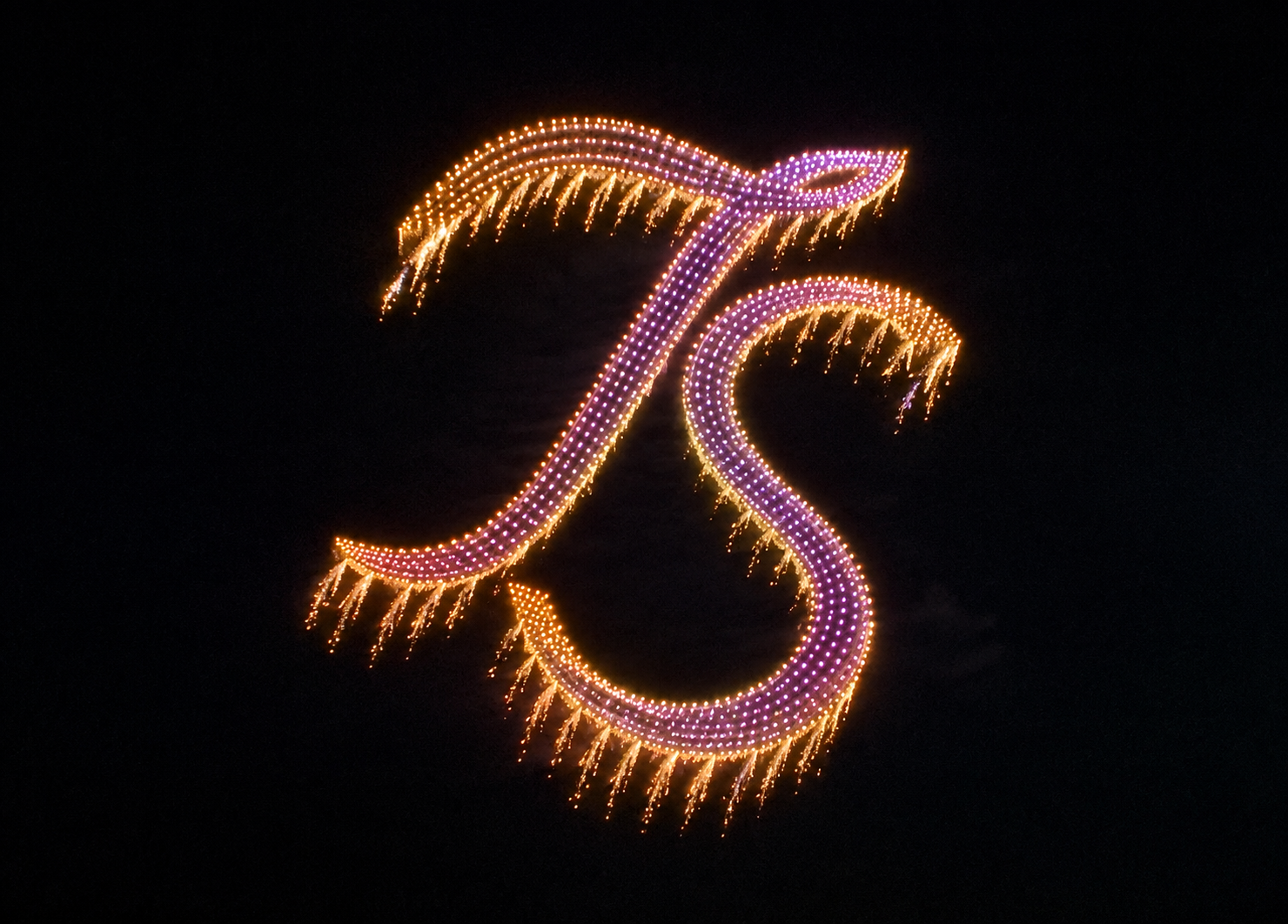 Gold and purple drone light monogram formation over the show site in Verona, New York