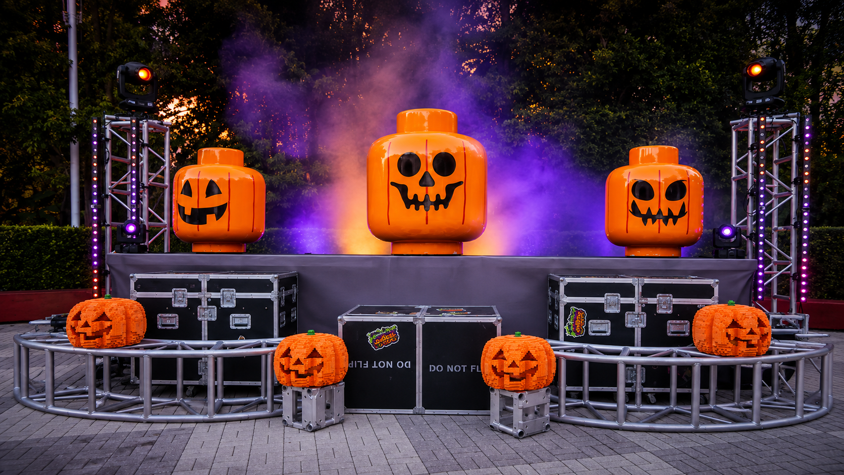 Jammin Jacks stage at LEGOLAND Florida Resort with LEGO pumpkin heads, fog effects, and road cases at dusk
