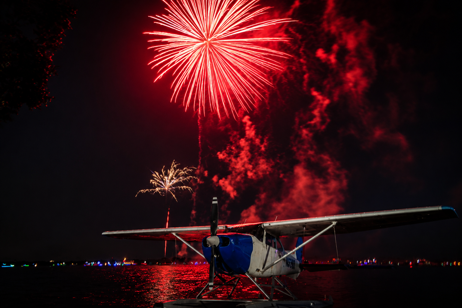 Red aerial burst over the water during the Tavares July 4th fireworks display