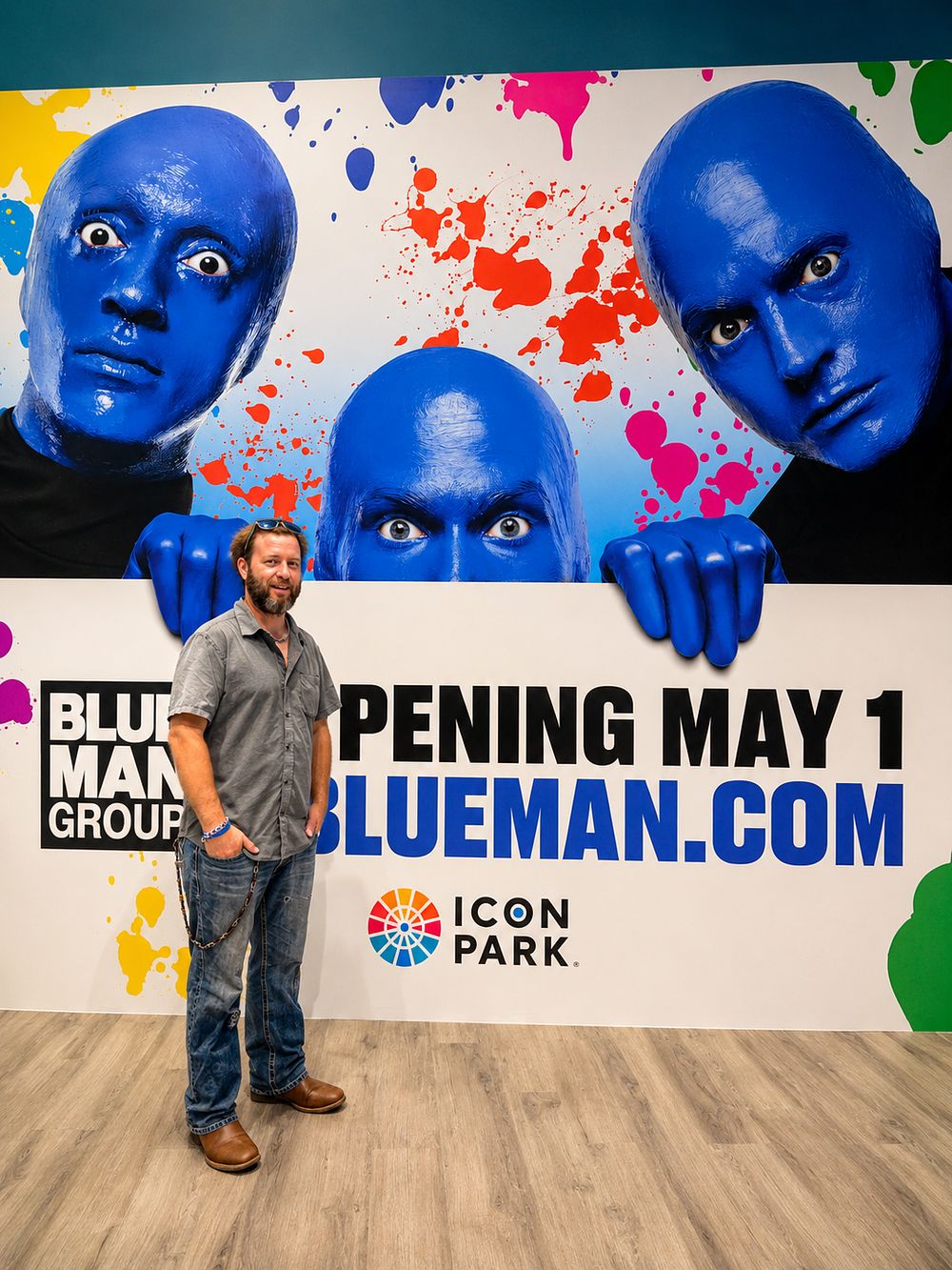 Crew member in front of the Blue Man Group opening display at ICON Park, Orlando