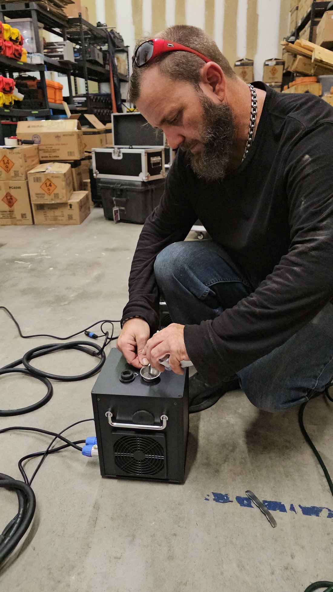 Crew member testing a cold spark machine in the Imperial Pyro shop