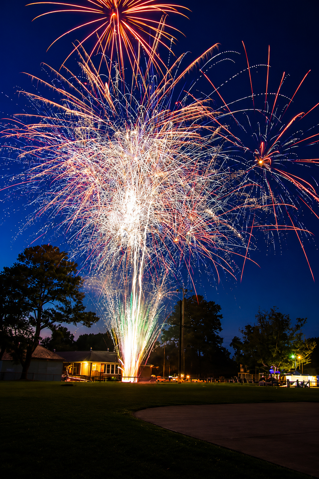 A permitted professional fireworks display at dusk