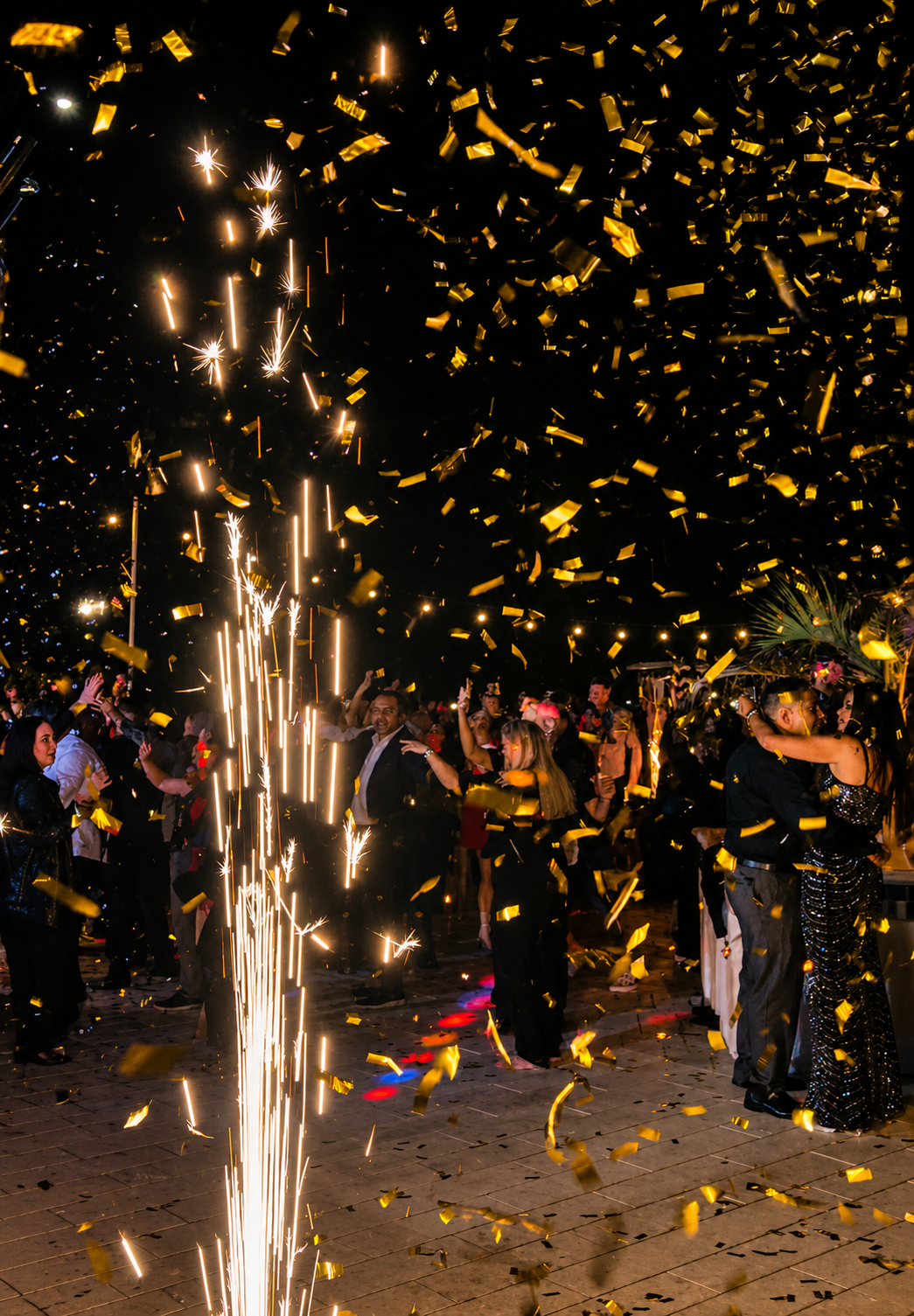 Golden confetti and sparklers over crowd at Hard Rock Hotel