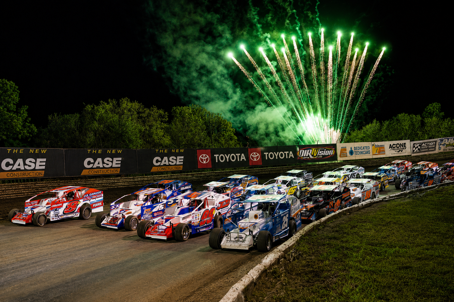 Green fireworks over dirt track race cars at Volusia Speedway Park