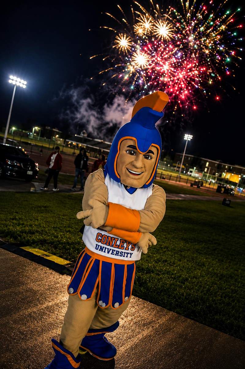 Virginia State University mascot with fireworks and stadium lights at night