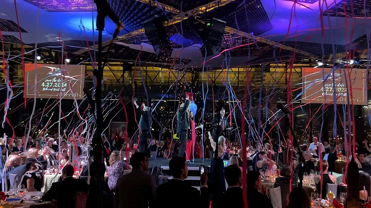 Red, white, and blue streamers falling at a gala event