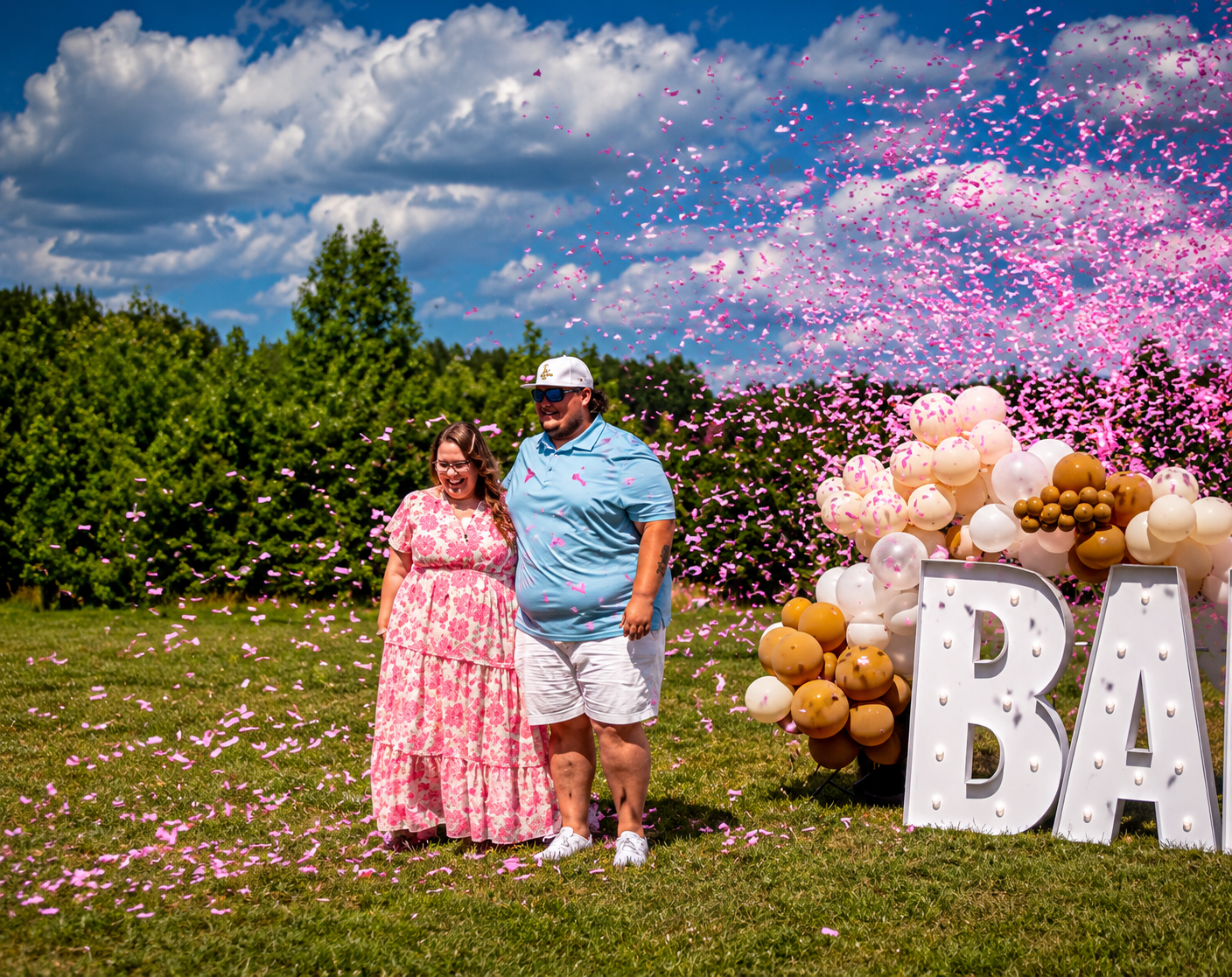 Pink confetti burst at a gender reveal celebration