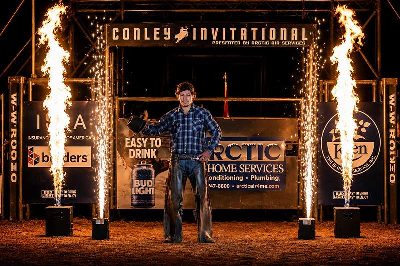 Flame jets and sparkler fountains at the Conley Invitational rodeo at night