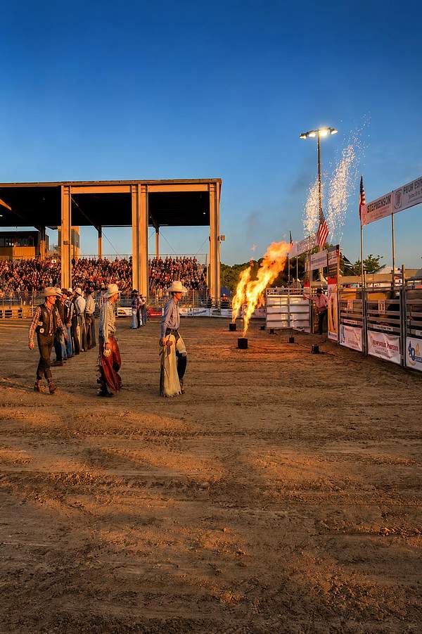 Flame effects and sparks at a rodeo arena at golden hour