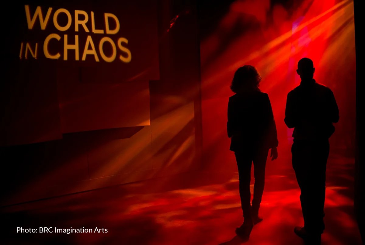 Light beams cutting through atmospheric haze in World in Chaos at Museum of the Bible