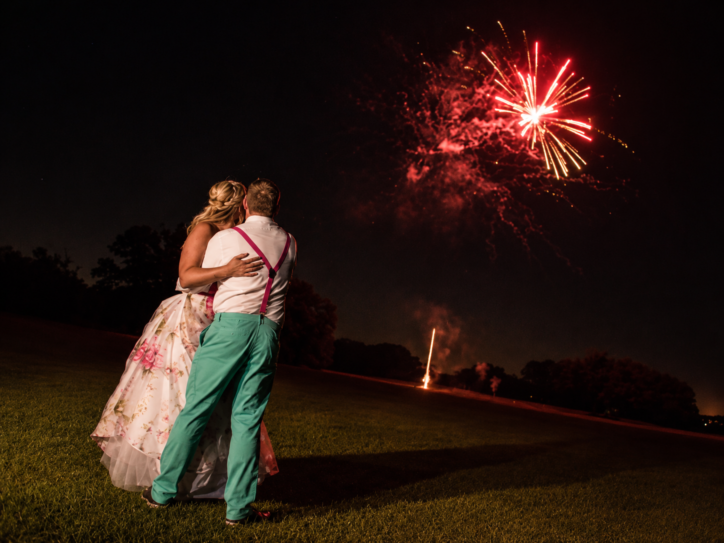A couple watching their wedding fireworks